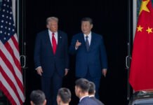 China accuses US of ‘AI hegemonism’, warns of countermeasures Chinese and US flags with data center, symbolising AI and geopolitical tension