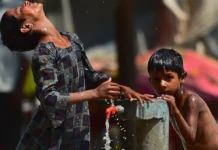 Silent Crisis: Climate Change and Heat Stress Expose 145 Million Indian Children to Severe Health Hazards Young school children drinking water during an intense heatwave in India