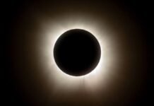 Total Solar Eclipse 2026: Europe Prepares for Rare Sky Show Spectators wearing eclipse glasses watch the Total Solar Eclipse 2026 over northern Spain as the Sun's corona becomes visible.