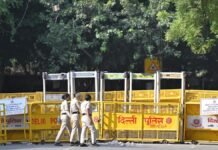 Delhi Police Detains Over 100 Demonstrators Marching Toward Election Commission Headquarters Police personnel and barricades halting demonstrators carrying the national tricolor near Gole Dak Khana in New Delhi.