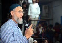 Congress Counters Asaduddin Owaisi’s Call for Muslim Leadership in UP, Questions His Record in Telangana AIMIM president Asaduddin Owaisi speaking passionately at a political podium in Uttar Pradesh.